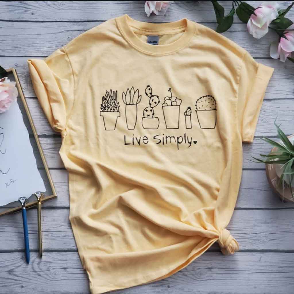 Dusty yellow color tee with cactus images and live simply quote.