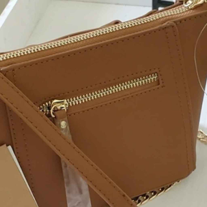 Mini tan cross body bag with bow detailing on front. Back side.