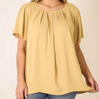 Plus size light mustard color short sleeve top with gathered detailing.