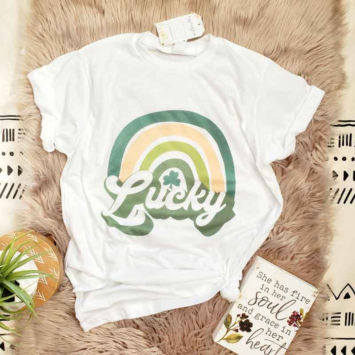 White color short sleeve tee with lucky quote and rainbow image in shades of green. Featuring a clover.